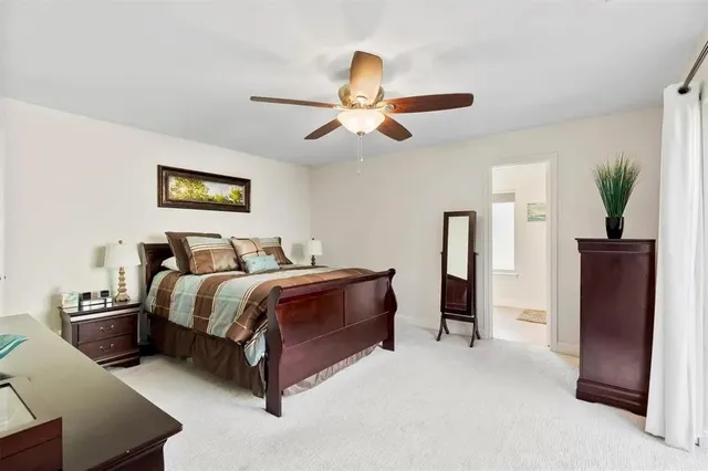 a spacious bedroom with a bed and a chandelier