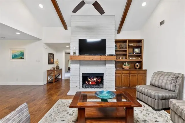 a living room with furniture fireplace and flat screen tv