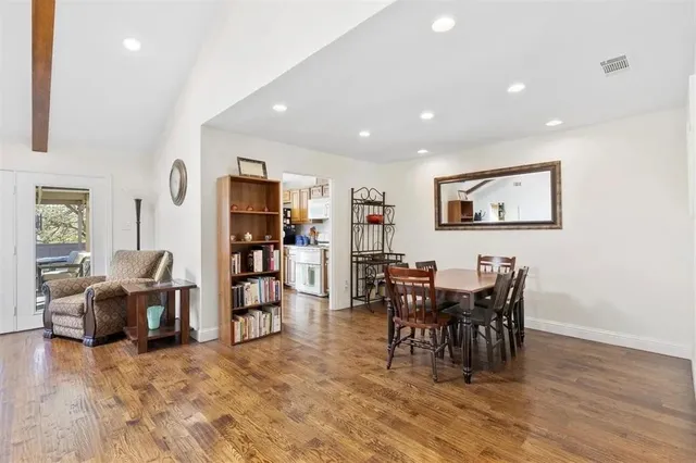 a view of a dining room with furniture and chandelier