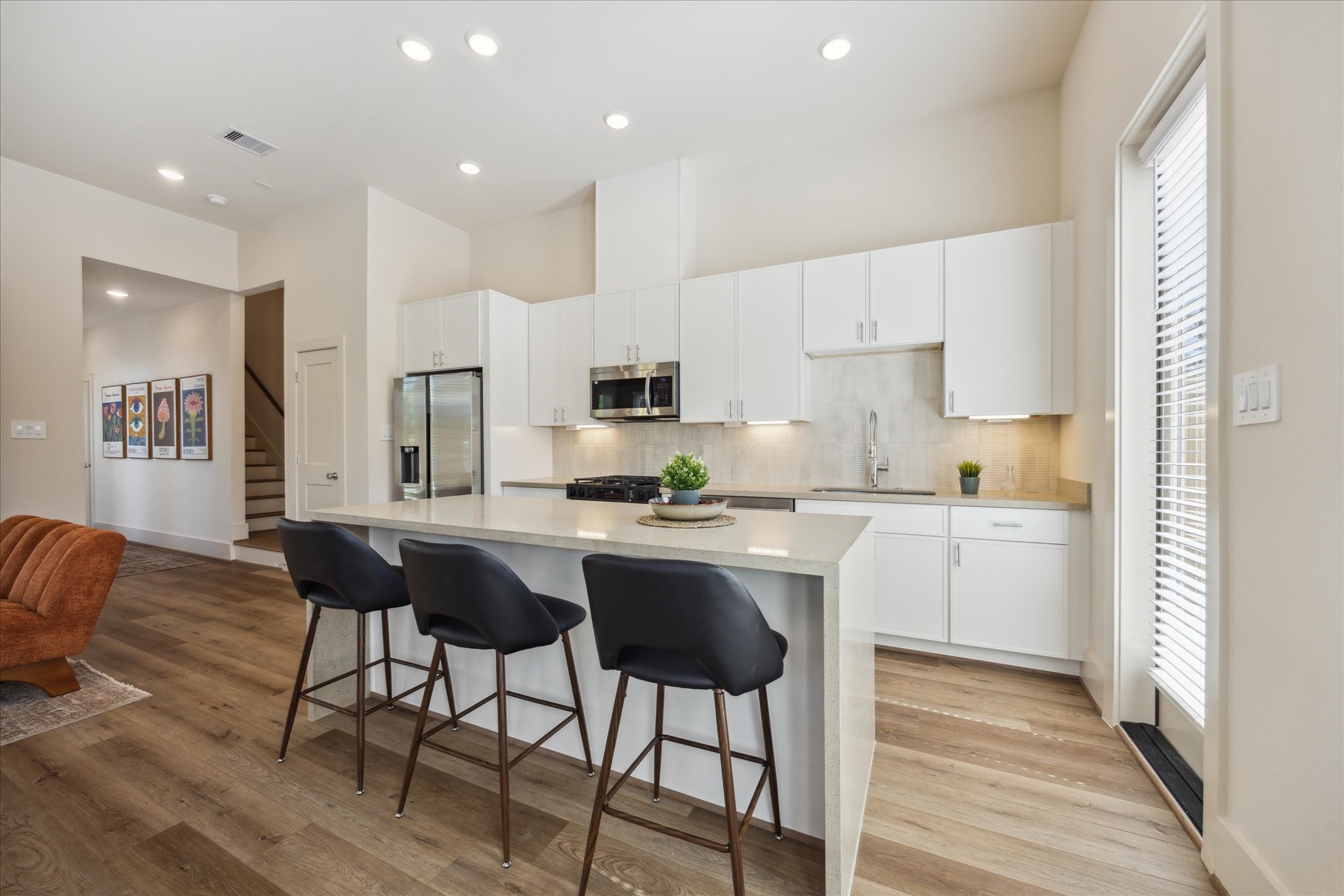 5903 Urban Pines Street Houston, TX 77091 - Photo 7 of 42 a kitchen with granite countertop white cabinets and stainless steel appliances