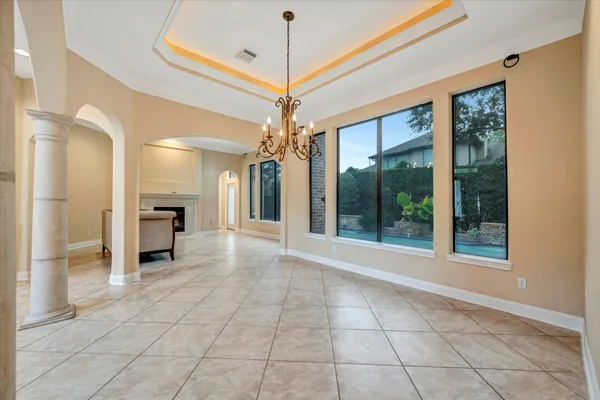 a view of a big room with windows and chandelier