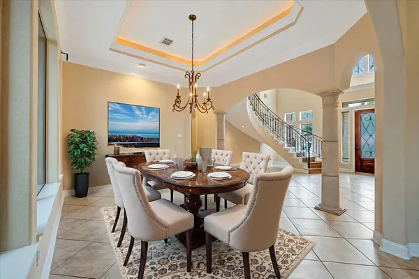 a view of a dining room with furniture and a chandelier