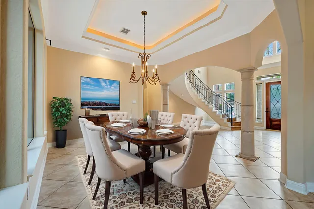 a view of a dining room with furniture and a chandelier