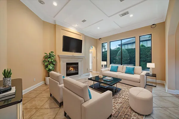 a living room with furniture a fireplace and a flat screen tv