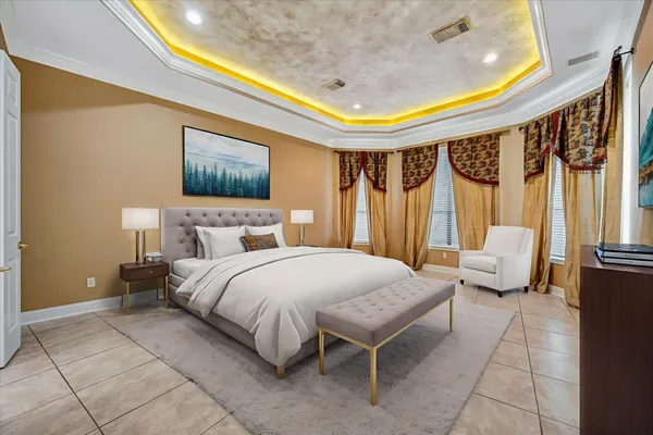 a spacious bedroom with a bed and a mirror