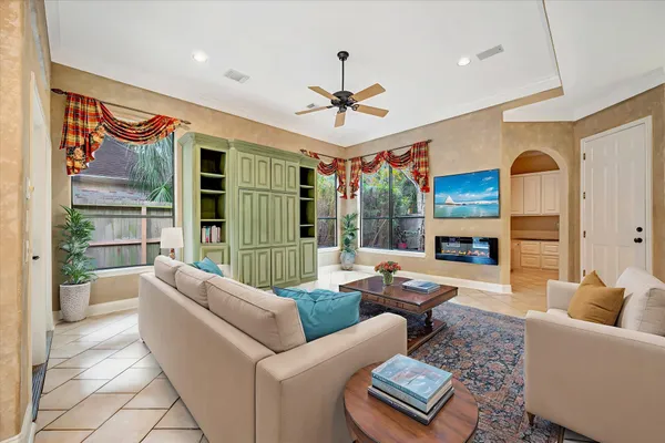 a living room with furniture fireplace and a large window