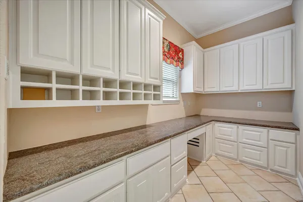 a kitchen with granite countertop white cabinets and sink
