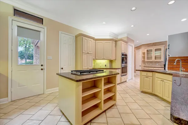 a kitchen with stainless steel appliances granite countertop a stove a sink and a refrigerator
