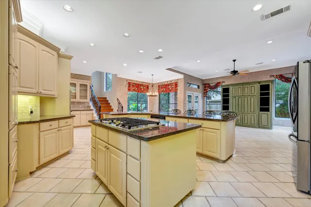 a kitchen with stainless steel appliances granite countertop a stove and a sink