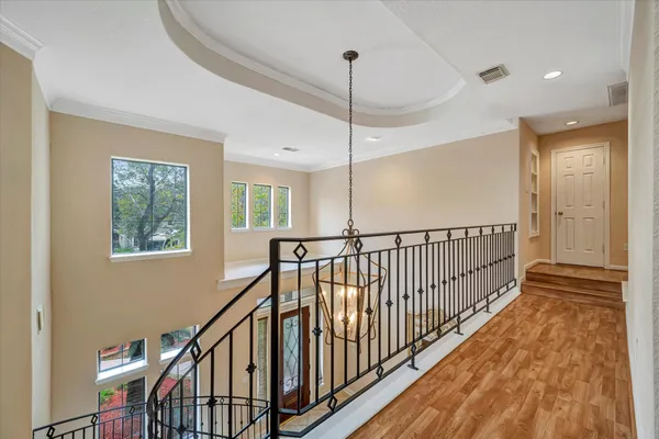 a view of staircase with wooden floor and fan