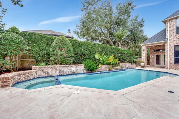 a view of a house with a yard and a garden
