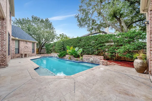 a view of a swimming pool with a patio