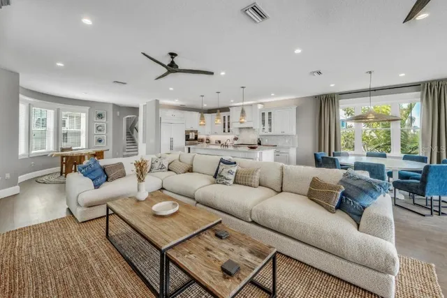 a kitchen with stainless steel appliances granite countertop a sink a stove and chairs