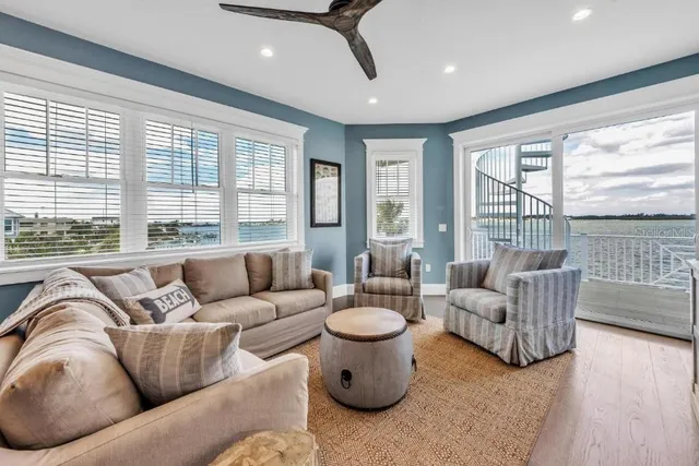 a kitchen with stainless steel appliances granite countertop a table chairs and a refrigerator