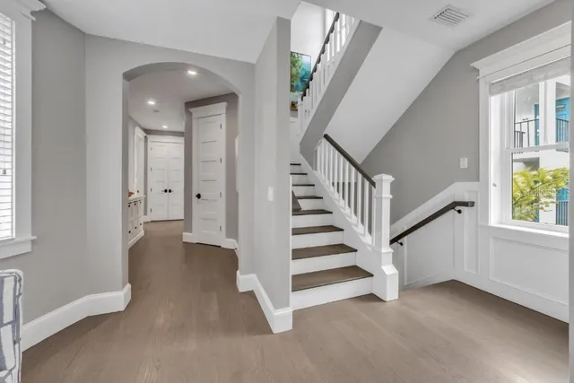 a spacious bathroom with a double vanity sink a large mirror and a bathtub