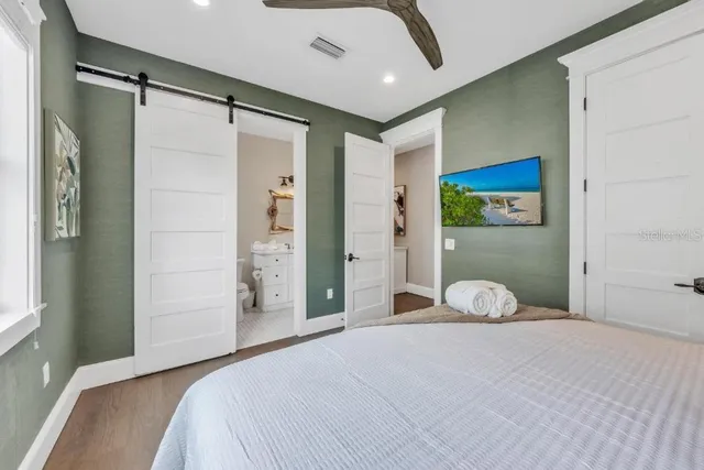 a bedroom with a large bed and a window