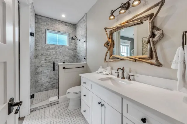 a bathroom with a sink a toilet and a mirror