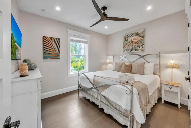 an aerial view of a swimming pool with outdoor seating and yard
