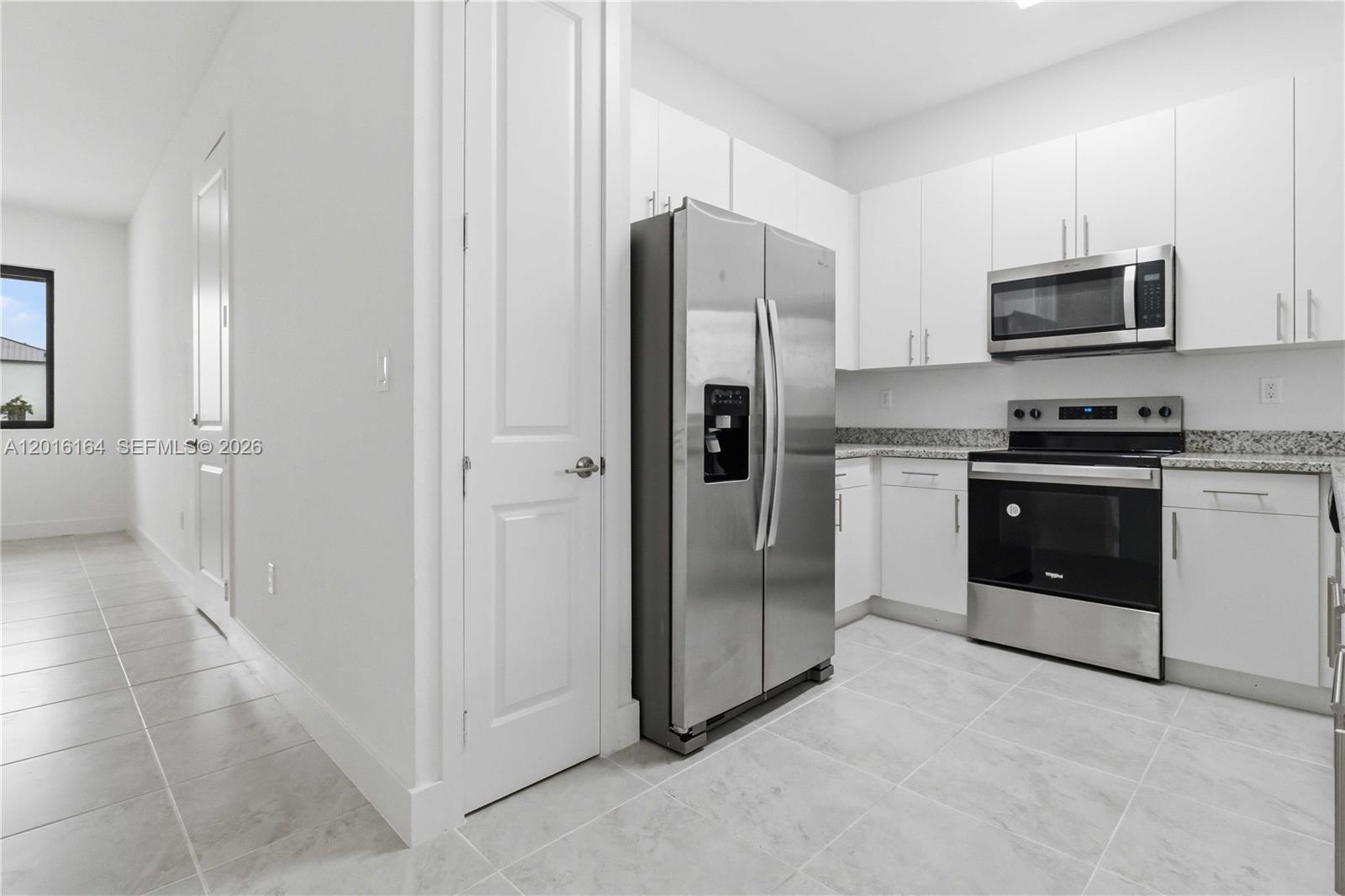 18901 Southwest 316th Street Homestead, FL 33030 - Photo 14 of 33 a kitchen with stainless steel appliances a refrigerator stove and sink