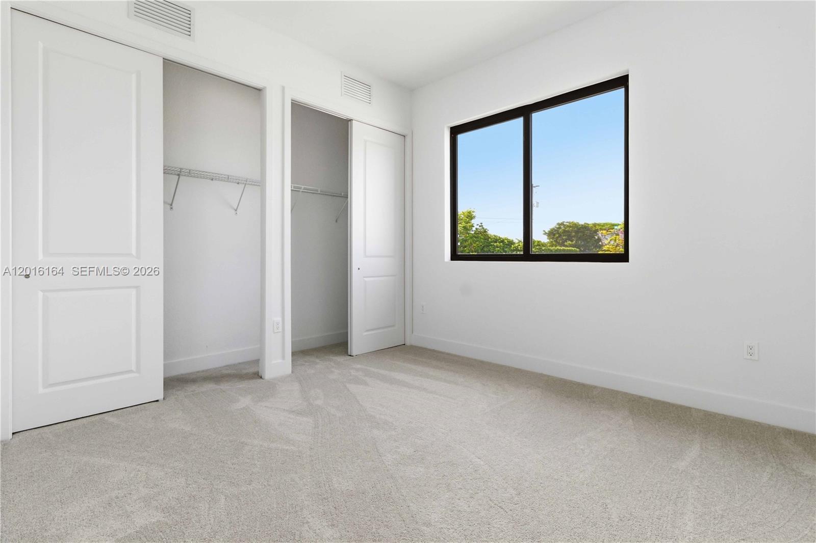 18901 Southwest 316th Street Homestead, FL 33030 - Photo 15 of 33 an empty room with windows and closet