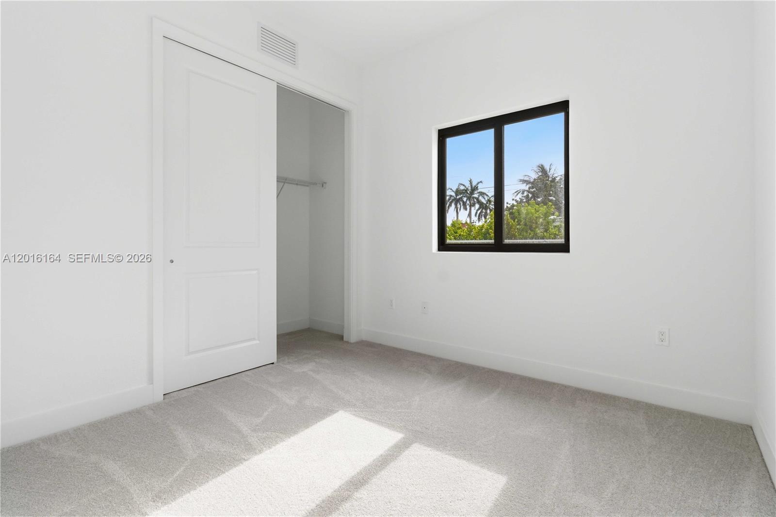 18901 Southwest 316th Street Homestead, FL 33030 - Photo 17 of 33 an empty room with windows and closet