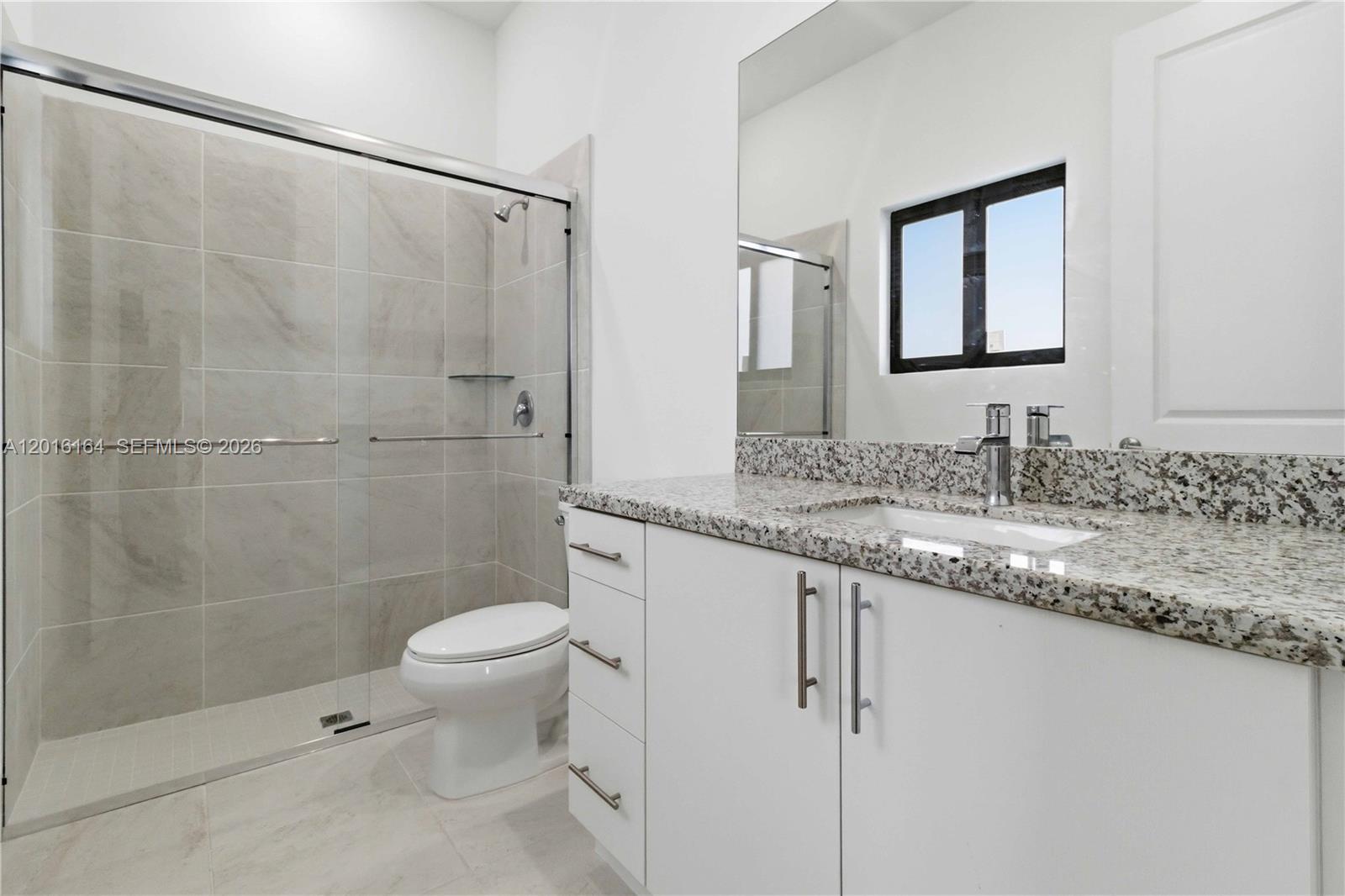 18901 Southwest 316th Street Homestead, FL 33030 - Photo 26 of 33 a bathroom with a granite countertop sink toilet and shower