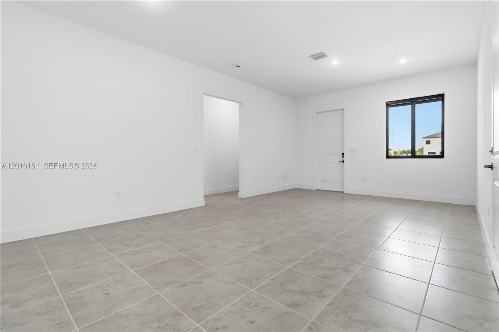 18901 Southwest 316th Street Homestead, FL 33030 - Photo 6 of 33 a view of an empty room with a window