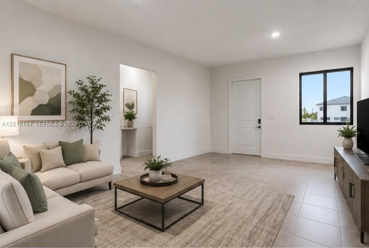 18901 Southwest 316th Street Homestead, FL 33030 - Photo 7 of 33 a living room with furniture and a potted plant