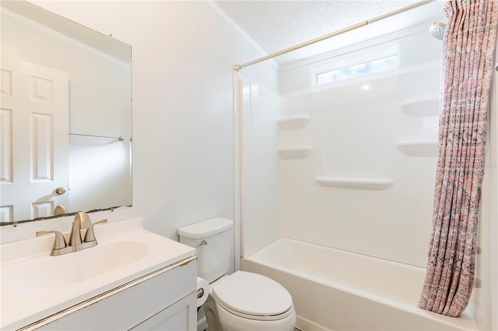 16314 Tiger Trail Spring Hill, FL 34610 - Photo 33 of 43 a bathroom with a sink toilet and shower