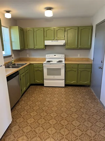a kitchen with a sink and a stove top oven