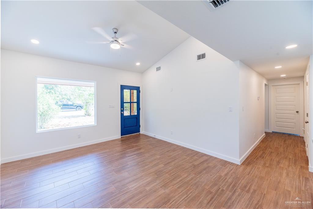 214 South 28th Street McAllen, TX 78501 - Photo 5 of 9 a view of an empty room with wooden floor and a window