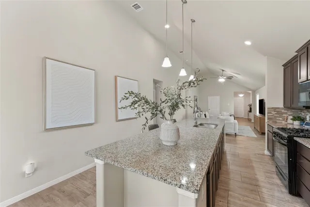 a dining room with furniture and potted plants