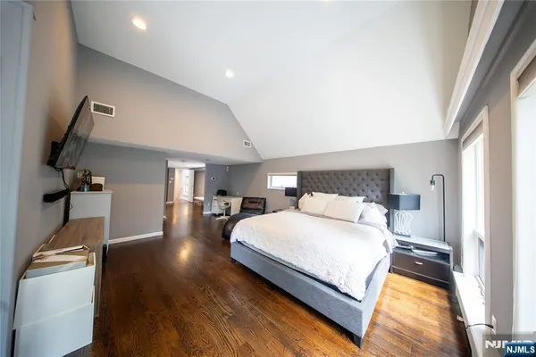 a bedroom with a bed and a large window