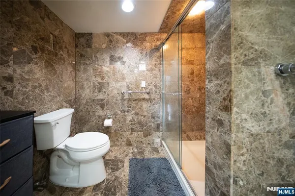 a white toilet sitting next to a shower curtain