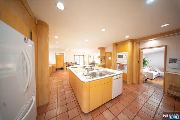 a kitchen with a stove a refrigerator and a cabinets