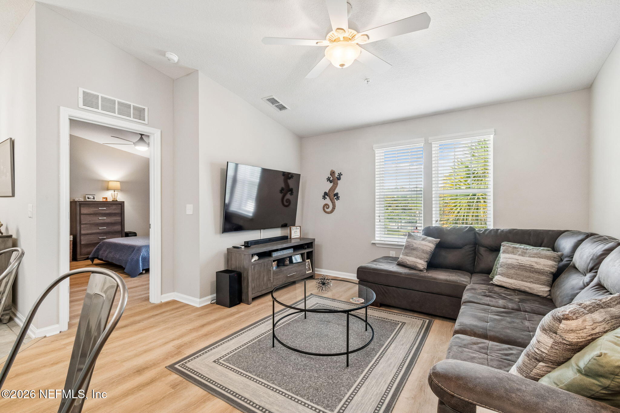 2113 Golden Lake Loop St. Augustine, FL 32084 - Photo 7 of 50 a living room with furniture a flat screen tv and a large window