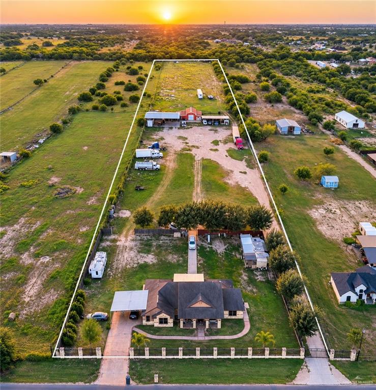 22811 Skinner Road Edcouch, TX 78538 - Photo 3 of 38 Expansive property with a stone facade residence, asphalt shingle roof, and a covered carport