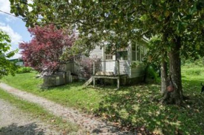 1207 Jaybird Road Monroe, TN 38573 - Photo 2 of 8 a backyard of a house with table and chairs