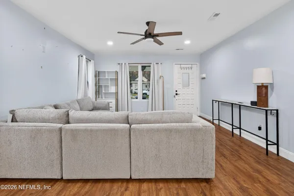 a living room with furniture and wooden floor