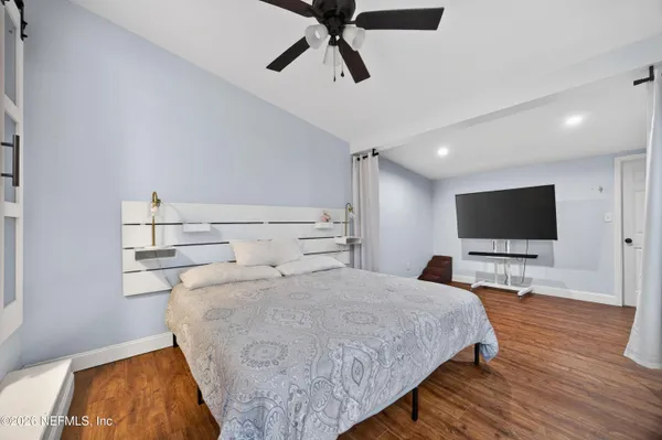 a bedroom with a bed and a flat screen tv