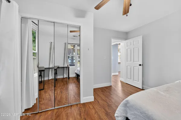 a view of a hallway with wooden floor and staircase