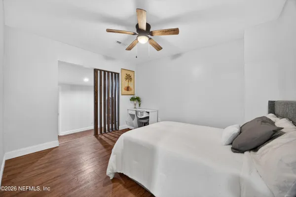 a bedroom with a bed and a ceiling fan