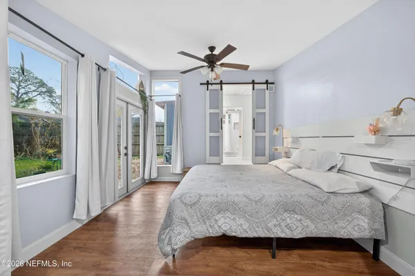 a bedroom with a bed and a chandelier