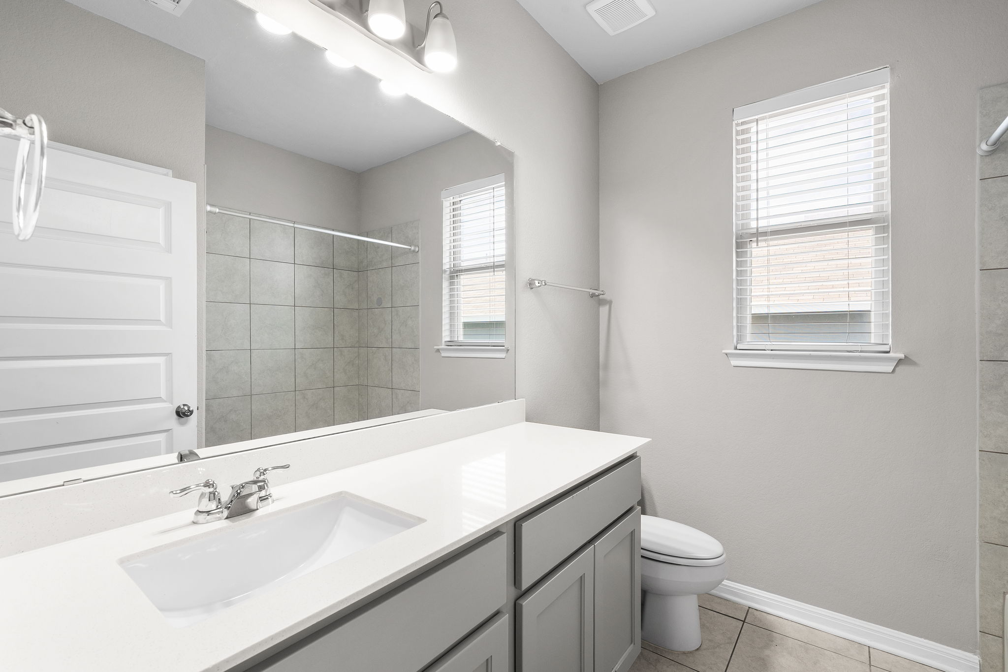 313 Mclintock Road Jarrell, TX 76537 - Photo 7 of 40 A well-appointed bathroom features a single vanity, sleek fixtures, and convenient shower space.