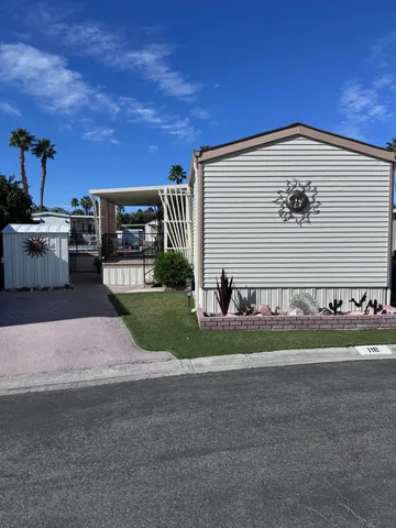 a view of a house with a yard and a garage