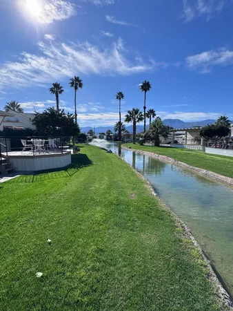a view of a swimming pool and a yard