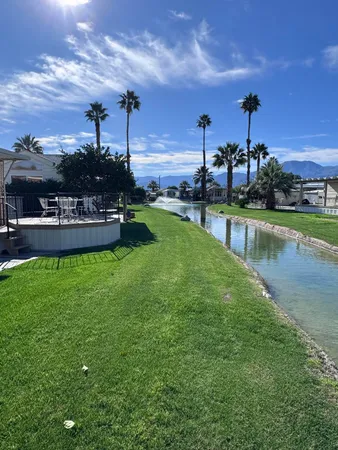 a view of a swimming pool with a yard