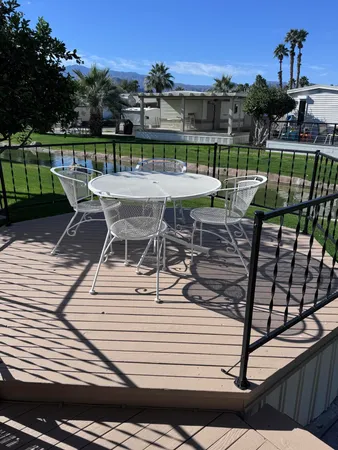 a view of a patio with couches table and chairs and potted plants