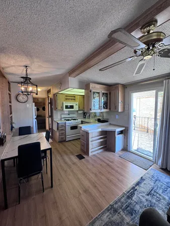 a living room with stainless steel appliances kitchen island granite countertop furniture and a kitchen view