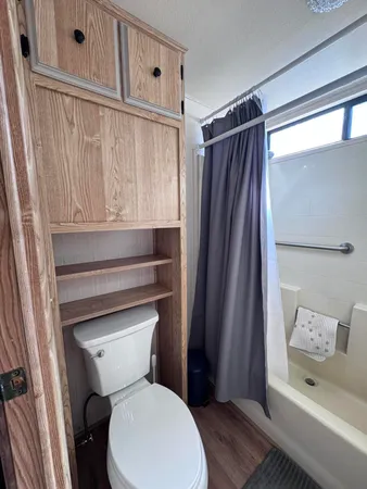 a bathroom with a toilet and a shower